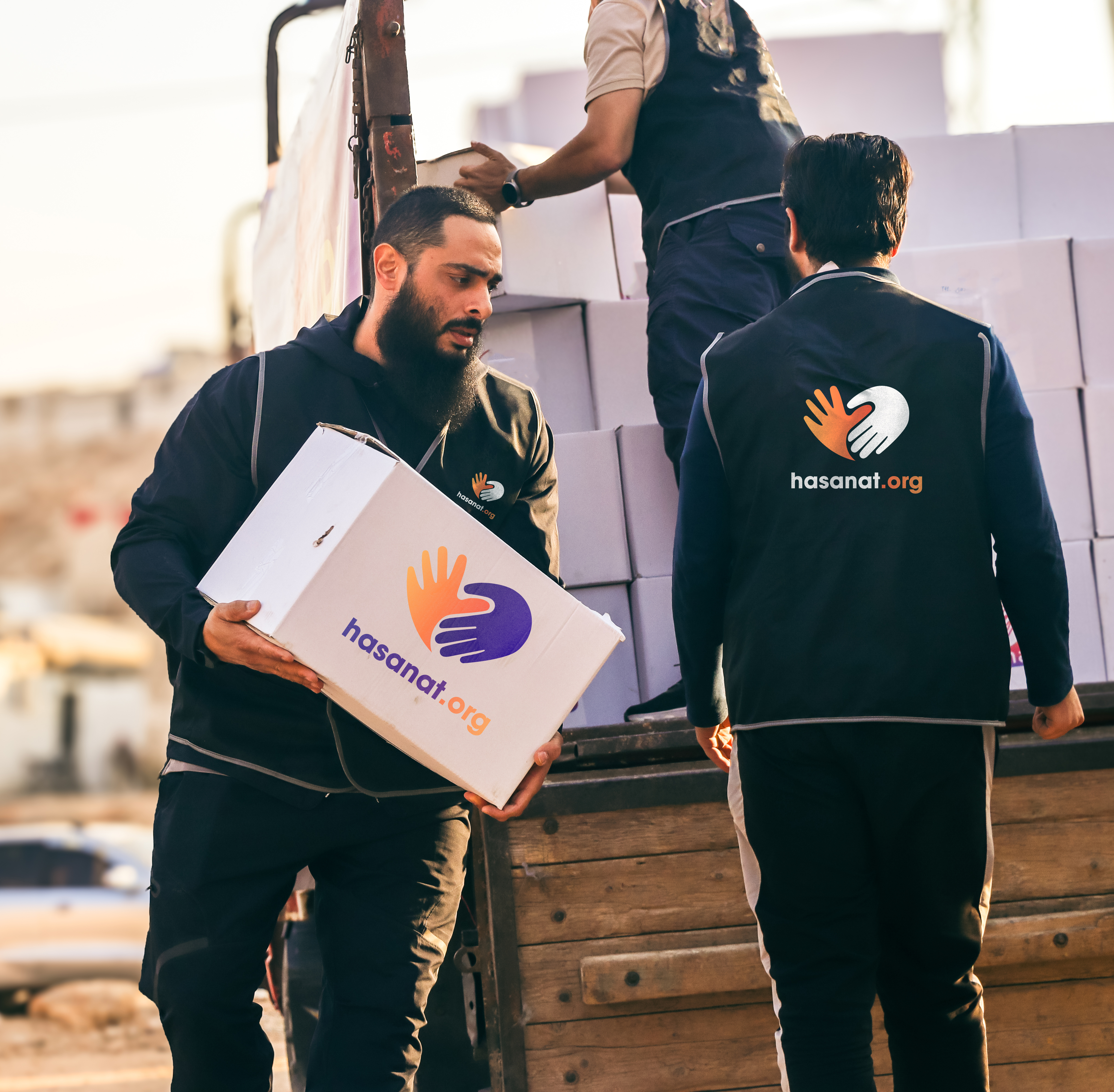 Hasanat volunteers distributing hygiene kits and supplies to children